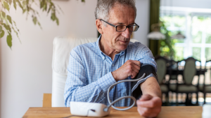 A man monitoring his blood pressure at home